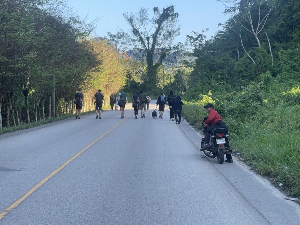 Travelers-Walking-Past-Roadblock